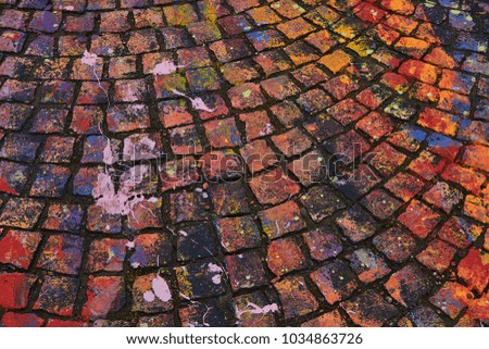 The stone pavement of the city is painted with colored chalk. Various bright colors . Texture in the ham. Abstract background.