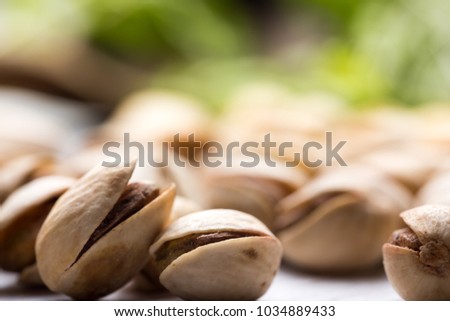 pistachios on a white table with blury backround