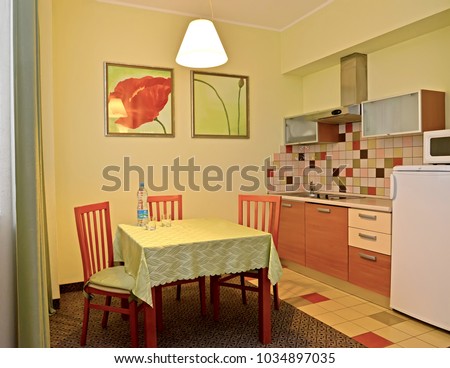  An interior of kitchen in green tones. Hotel room