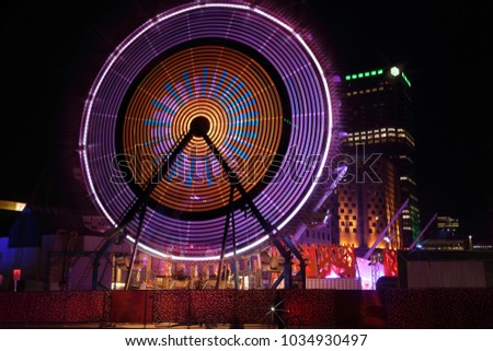 Luminous Ferris wheel during Montreal vivid Festival of Lights. Colorful illuminated silhouettes in the night. Winter festival of arts. Outdoor family activities. Entertainment District.
