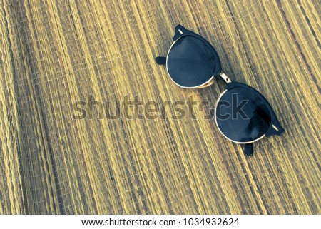 Vacation mode concept. Fashion sunglasses on beach rustic blanket. Top view. Place for text. Toned photo.