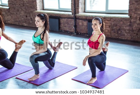 Multiracial Group of young  beautiful women in sportswear doing yoga exercises. Class of yoga or fitness