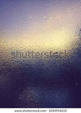 Blurred wet glass bright colorful background, shiny liquid abstraction copy space