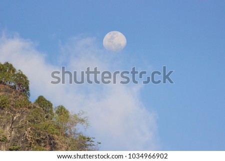 moon and blue sky in day