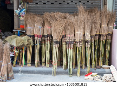 Group of wooden broom with long handle for sell at retail store, Yaowarat, Bangkok, Thailand