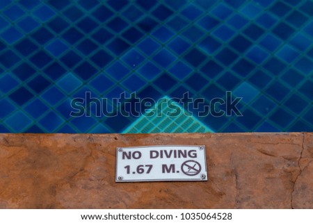 No diving sign water depth of 1.67 meters on side swimming pool.