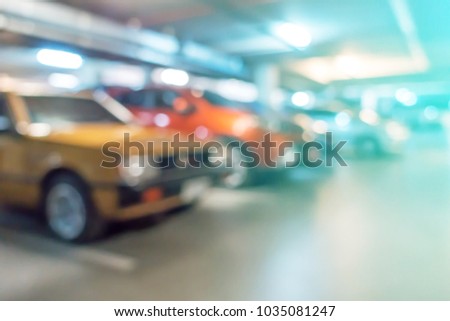 Abstract blurred cars parking with bokeh light , Underground parking with cars. Background for use as Background