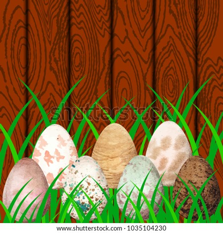Easter. Eggs with different watercolor stains on the background of wood and grass. Place for text