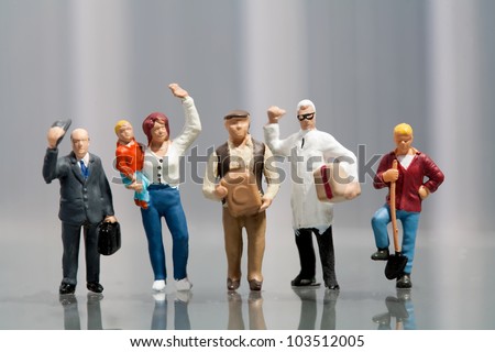 Line of diverse tiny miniature model people in population demographics representing a cross section of the community including a housewife, artisan, labourer, and professionals Royalty-Free Stock Photo #103512005