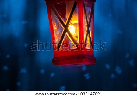 Red lantern is on blue window background