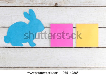 Blue rabbit paper cut out with two stickers. Copy space for text