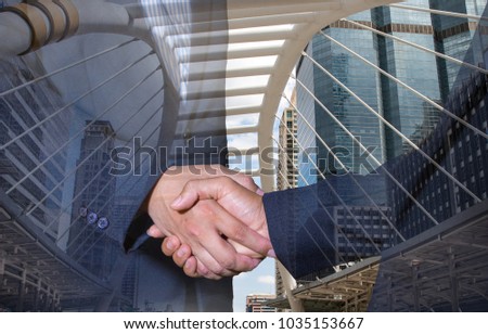 Double exposure of handshake and city.handshake and business people concepts. Two men shaking hands isolated on cityscape background. Close-up image of handshake between two business man.
