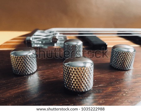 Selected focus on a volume knobs on a bass guitar