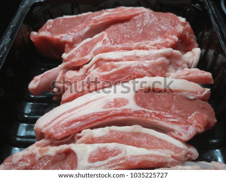 finest raw lamb chops in a black plastic tray