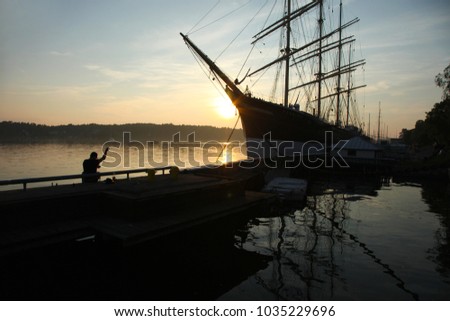 Old barque Pommern on sunset in Marienhamn on Aland islands Royalty-Free Stock Photo #1035229696