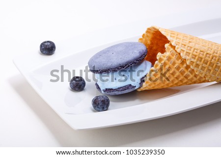 Blue ice cream and macaroons on plate. Cafe menu