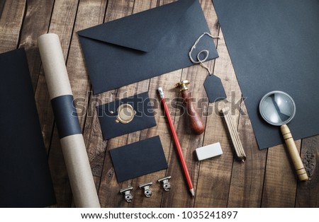 Blank black stationery set on wood background. Template for placing your design. For graphic designers presentations and portfolios.