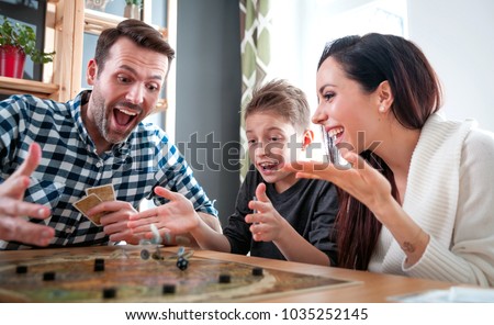 Happy family playing board game at home, happiness concept