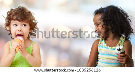 Two funny kid girls eating ice cream