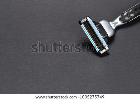 razor on a black background. Close-up of a razor blade. Royalty-Free Stock Photo #1035275749