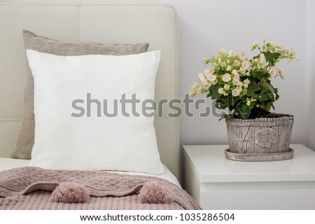 White pillow on bed in a cozy bedroom, Mockup