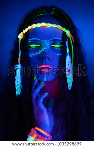 Neon hippie girl in blacklight on dark background Royalty-Free Stock Photo #1035298699