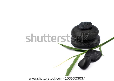 Black stone pile stock images. Black massage stones. Black stones on a white background. Massage stones for relaxation. Pile of black stones