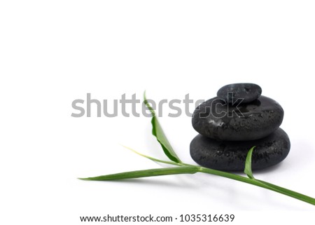 Spa still life stock images. Black massage stones. Black stones on a white background. Massage stones for relaxation. Pile of black stones