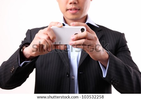 Asian businessman using a mobile camera on the white background