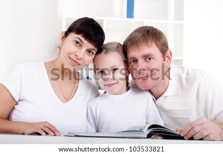 Family reading a book together, a family vacation