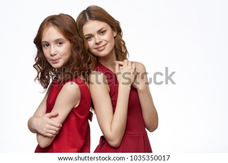  girls stand back to back on isolated background                              