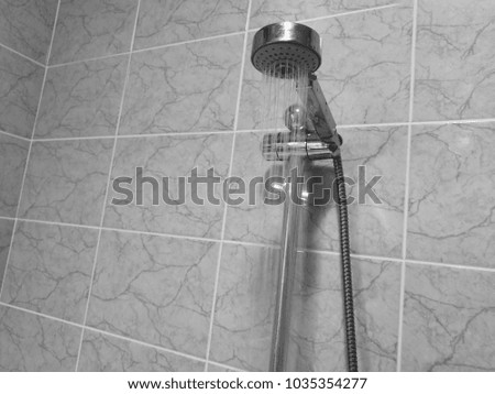 Black and white picture of the shower in the bathroom.