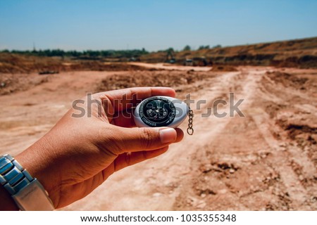 compass in hand with nature background