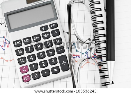 Business concept with notebook, glasses, pen and calculator