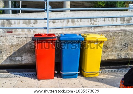 Three colorful trash bins for garbage separation