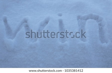 win. the inscription the text of the letters of the win in the snow. to win in the winter games