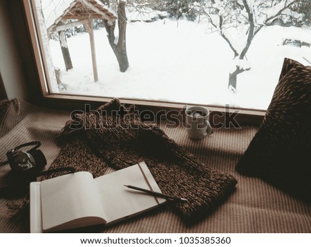 winter photography, white mug with coffee analog camera and book