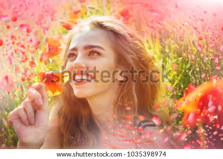 Girl in poppy meadow. Blooming poppy.
