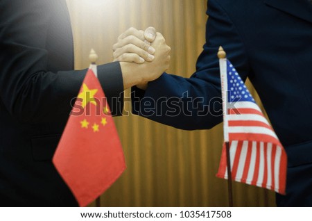 Businessmen of the two superpowers of the world. Holding hands to demonstrate clashed competition in business connectivity