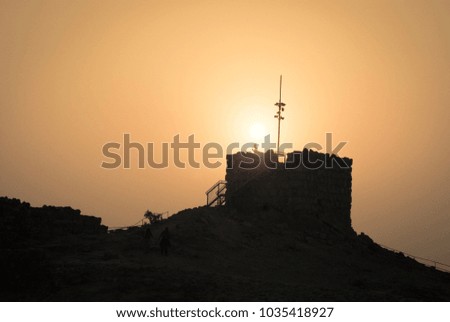 Horizontal picture of silhouette tower during sunrise in Massada, Israel