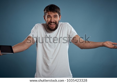  joyful man with a tablet on a blue background                              