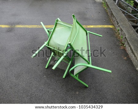 green chairs on asphalt terrace