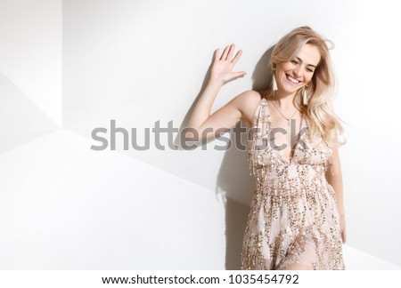 Beautiful woman holding 5% sale sign. Portrait of a laughing woman holding copyspace on the palms isolated on a white background