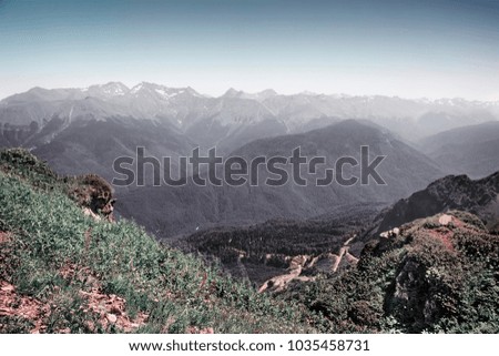 The mountainous landscape of the slopes covered by forest.