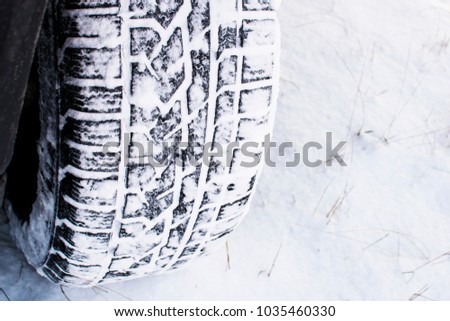 car wheel leaves a mark on the snow
