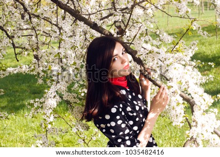
Girl in a blooming spring garden