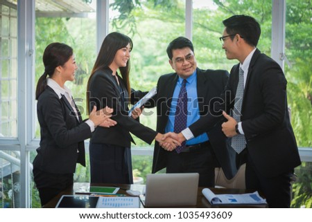 old-man congrats to his team in business meeting becasue of success work