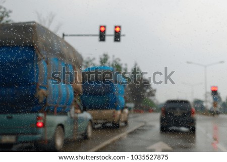Rain drop on the car's mirror while stop at the red traffic light. Car stop at the traffic light.