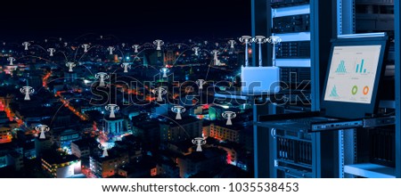 Wireless management center and telecommunication concept, data center with wireless access point device, kvm monitor and servers on rack and background of night city with wifi icon connectivity Royalty-Free Stock Photo #1035538453