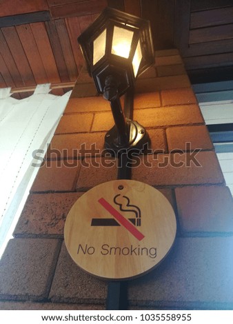 "No smoking" sign hanging in front of the toilet